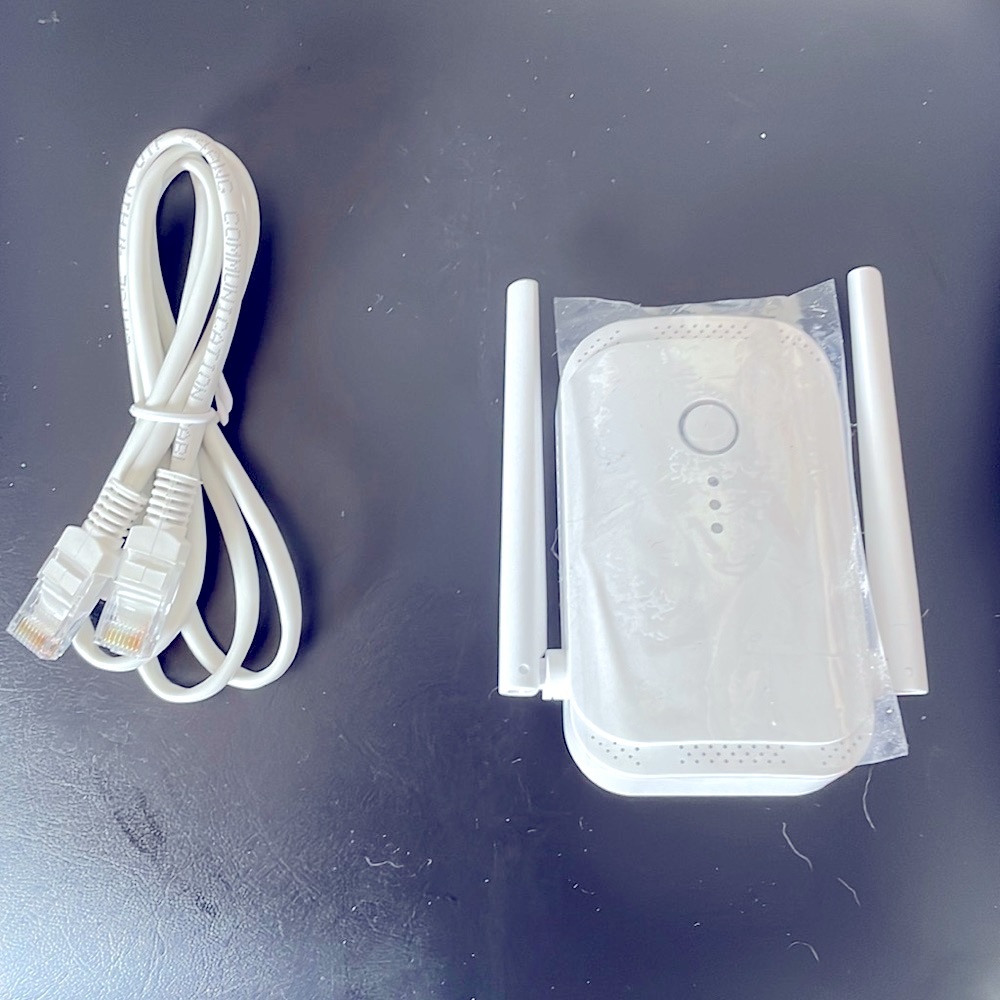 WiFi Extender with Ethernet Cable. White. Plugs into the wall. L4 x W2.5